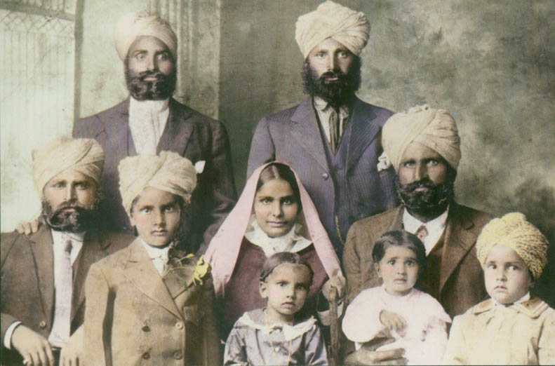 1916. The Dhillon family in Astoria. Seated 2nd and 3rd from left in middle row are: Rattan Kaur (mother) and Bakhshish Singh Dhillon (father). Children from left to right: Kapur, Karm, Katar, and Budh. The three unidentified men are friends. 